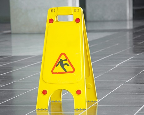 Wet floor sign suggesting Liability insurance