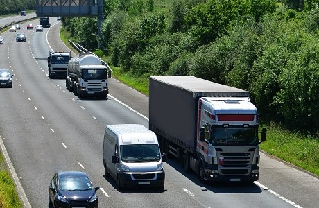 Various vehicles driving along a motorway with motor insurance