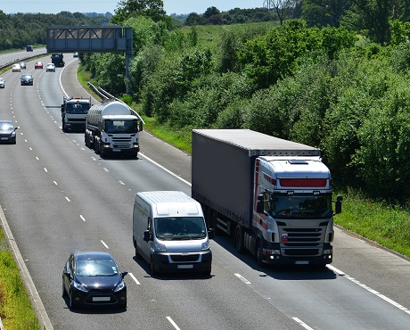 Various vehicles driving along a motorway with motor insurance