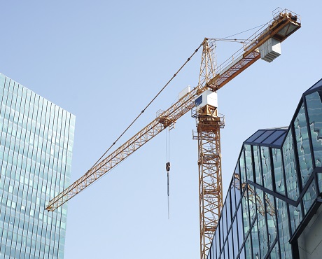 crane against glass city skyline, trade associations | Kerry London Construction insurance