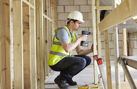 construction worker working on stud partitions representing builders insurance