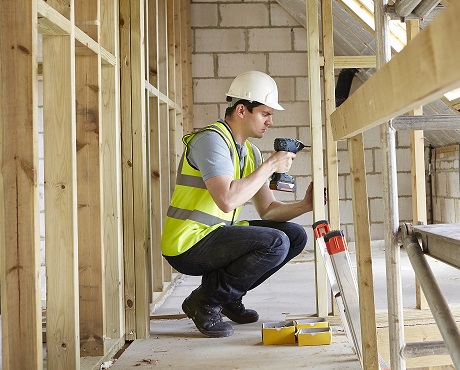 construction worker working on stud partitions representing builders insurance