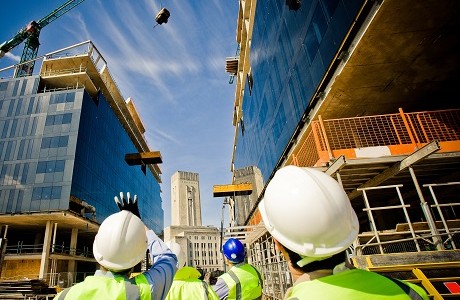 builders watching a crane in a city scene