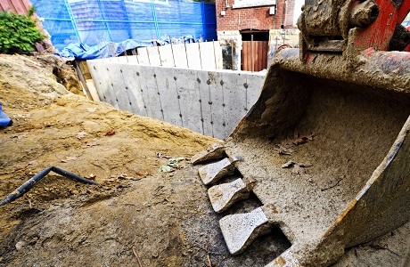 Basement being constructed with digger in foreground representing contract works insurance