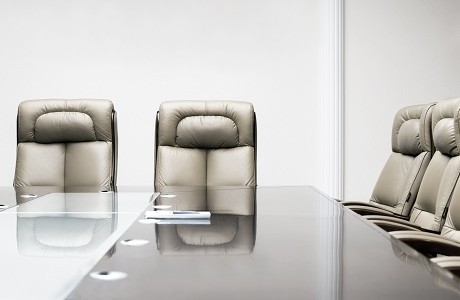 Chairs arranged around a board room table representing Directors and Officers insurance