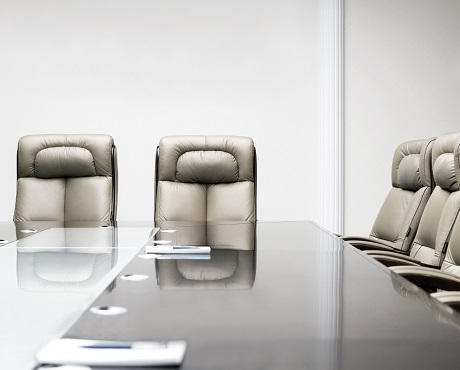 Chairs arranged around a board room table representing Directors and Officers insurance