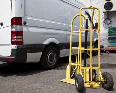 sack trolley in front of white van representing Goods in transit insurance