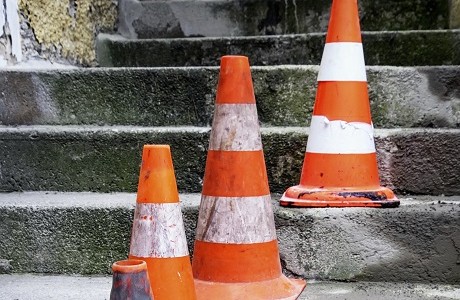 Traffic cones on steps representing public liability insurance