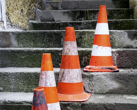 Traffic cones on steps representing public liability insurance